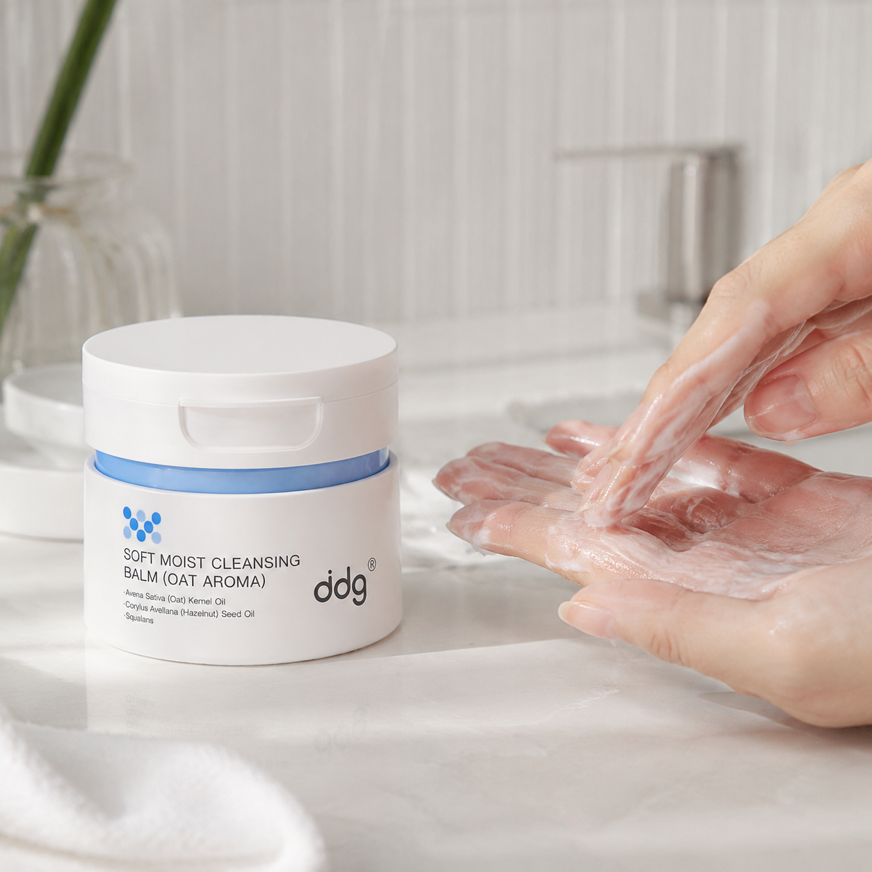 ddg Makeup Remover Cleansing Balm beside hands emulsifying balm with water